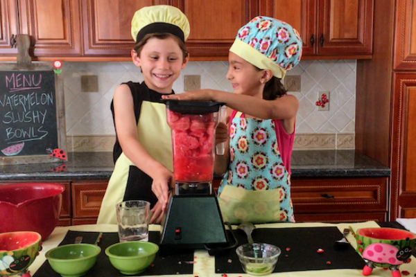 kids having fun making watermelon slushie bowls