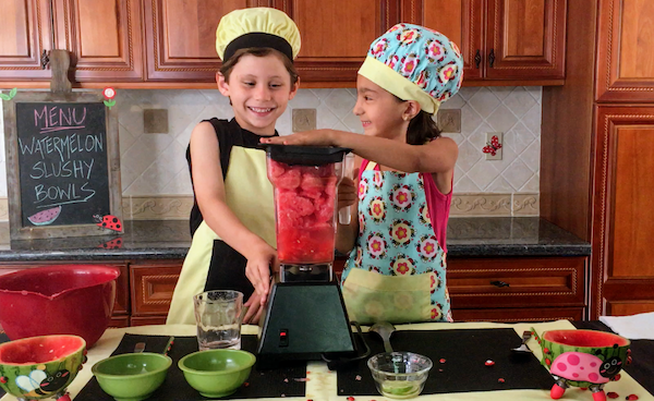 kids having fun making watermelon slushie bowls