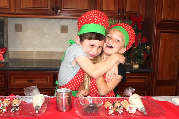 kids making christmas cannolis
