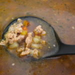 chicken sausage soup on ladel