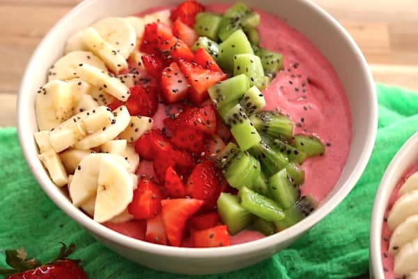strawberry banana smoothie bowl with fruit on top
