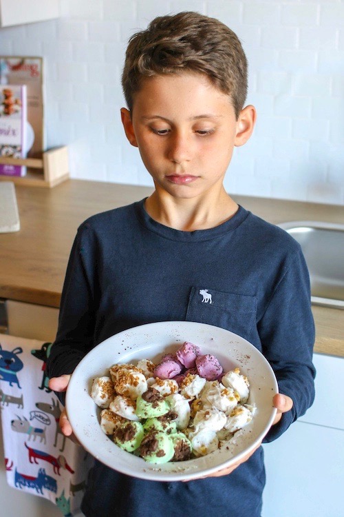 boy holding a bowl with frozen banana bites