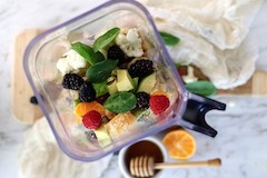 mixed veggies and fruit in blender top view feature image