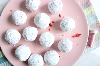 strawberry cake balls rolled in powdered sugar plated