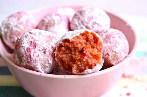 strawberry cake balls in pink bowl