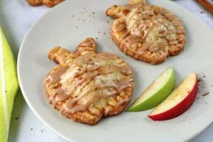 apple shaped hand pies with apples on plate