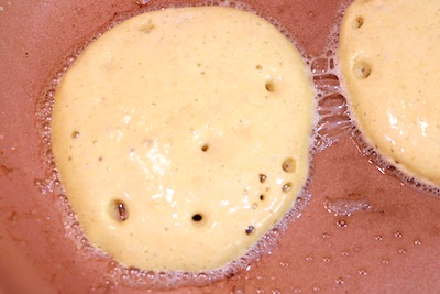 banana oat pancakes cooking in pan
