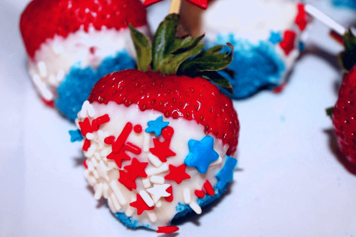 white chocolate dipped strawberries with star sprinkles