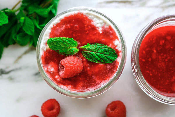 banana chia seed pudding with raspberry sauce on top