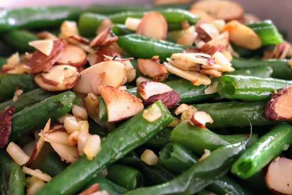 close up of kid-friendly green beans with crispy garlic and almonds