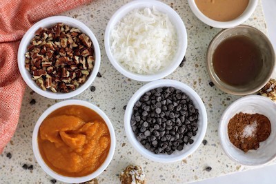 pumpkin protein balls with boys hands holding mix