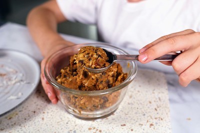 pumpkin protein balls with boys hands holding mix