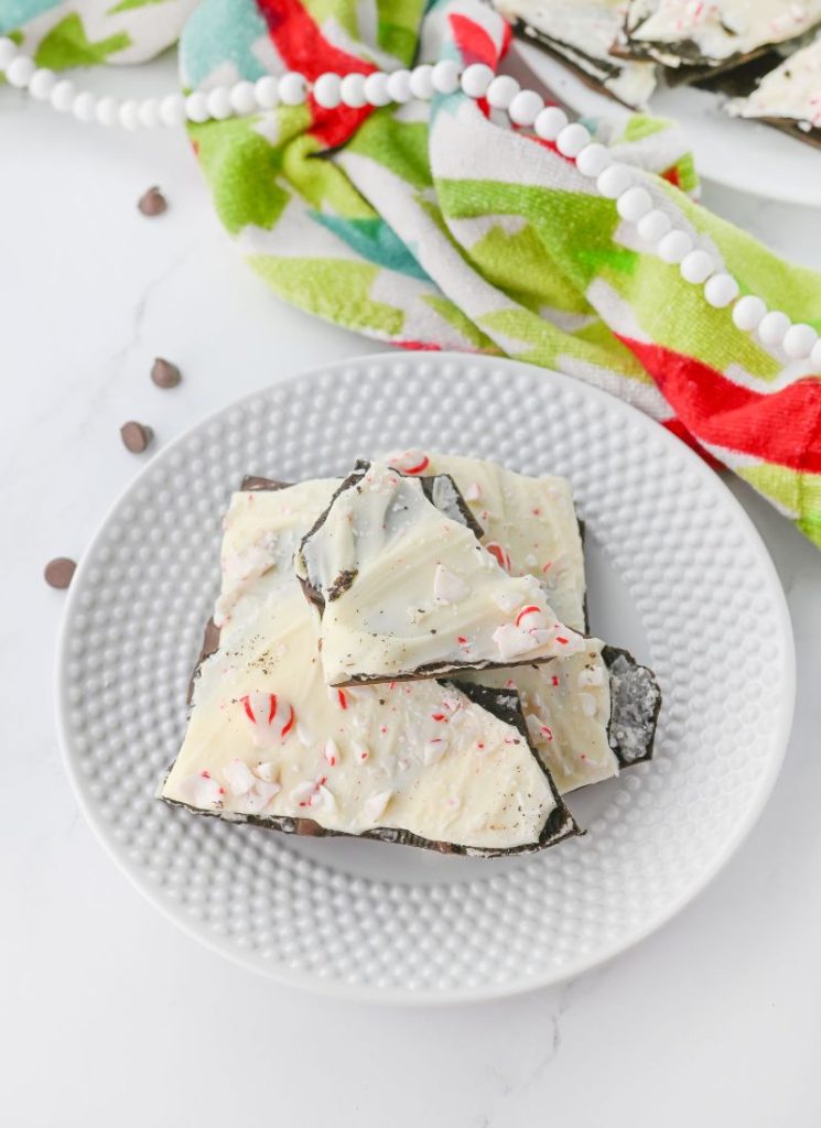 overhead shot of peppermint chocolate bark with Oreos on a plate - vertical view