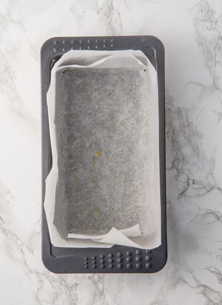 prepping the tin with baking parchment for lemon cake with oilve oil