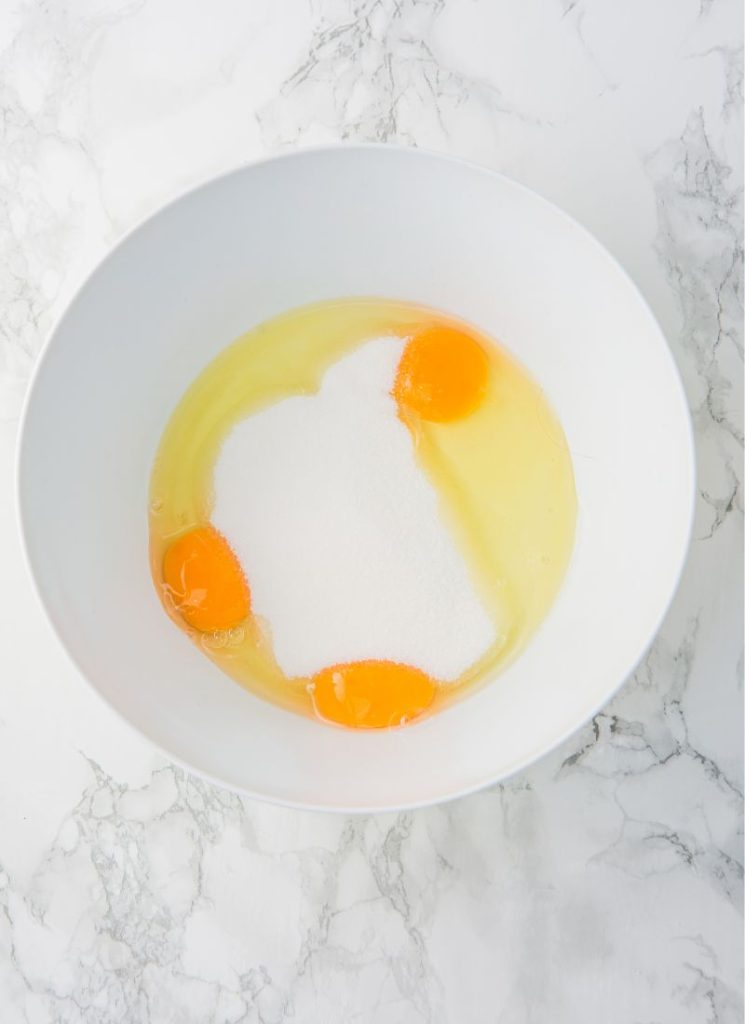 eggs and sugar in mixing bowl for lemon cake with oil and yogurt