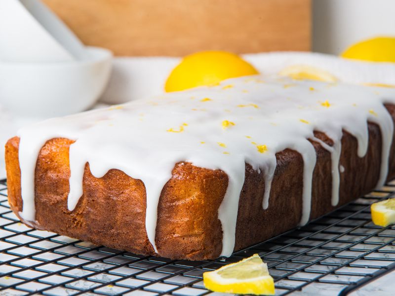 side view of baked and glazed yogurt lemon olive oil cake ready to eat!