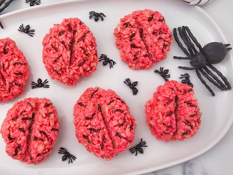 Gooey red rice krispie brains on a tray.